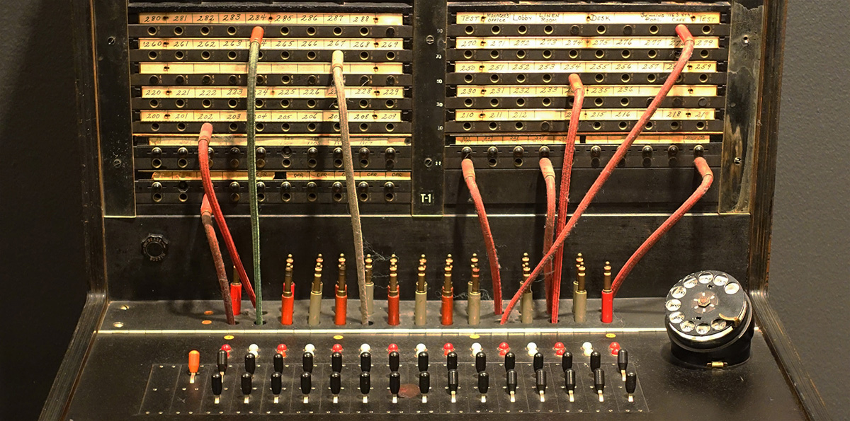 A Western Electric manual cord switchboard of about 1949, its jack field patched with cloth-covered cords.
