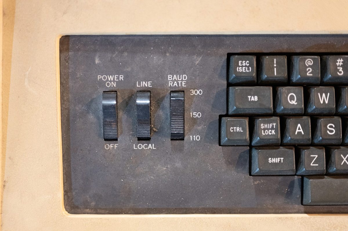 Power, line, and baud-rate switches beside a worn terminal keyboard