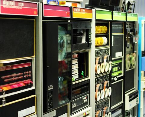 Digital Equipment Corporation minicomputers — a PDP-11, a PDP-8e, and a PDP-12 — on display in a museum.