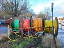 Reels of optical-fibre telecommunications cable.